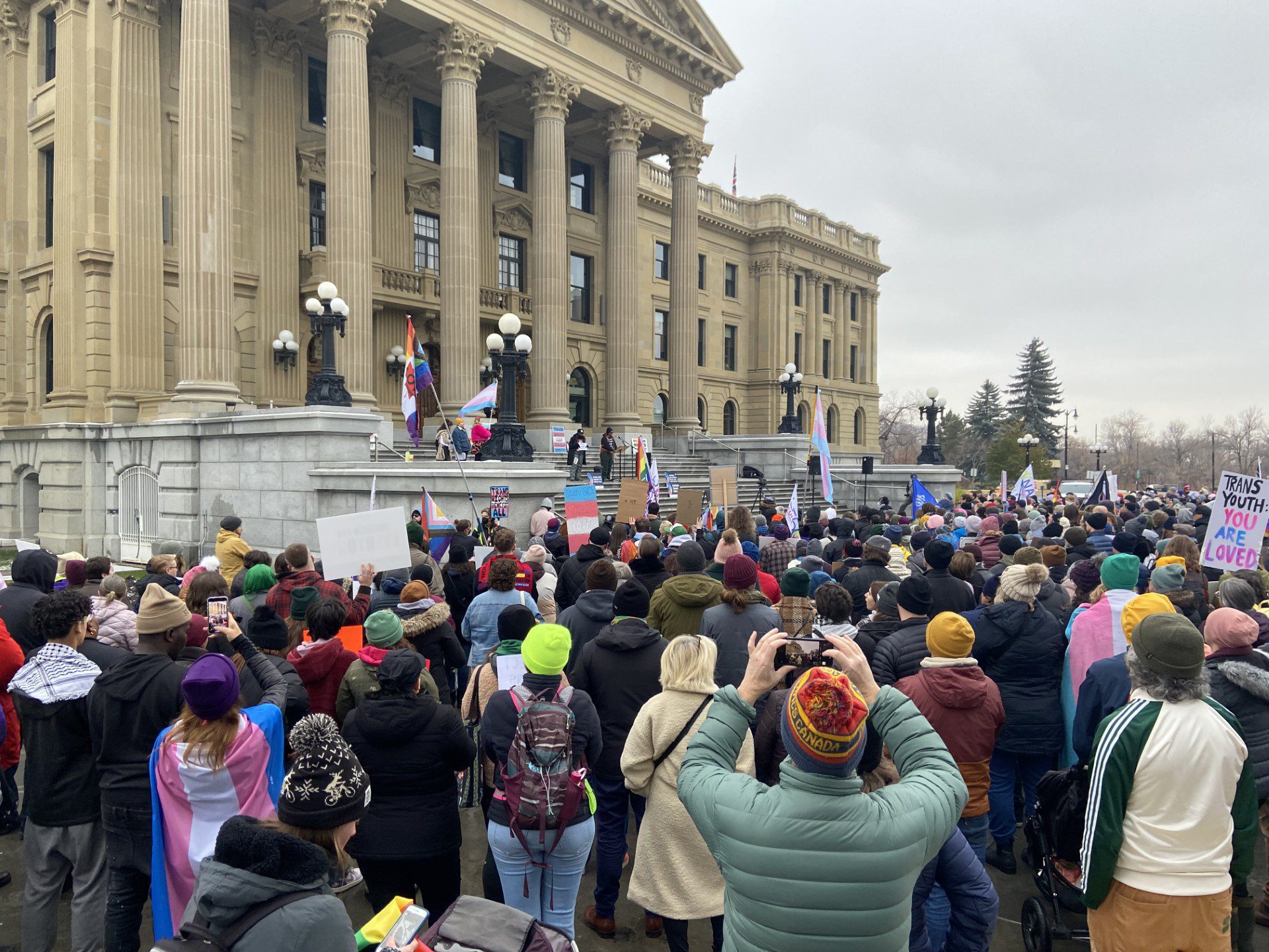 Protester Rally At Alberta Legislature To Oppose Bills Affecting Trans Rights