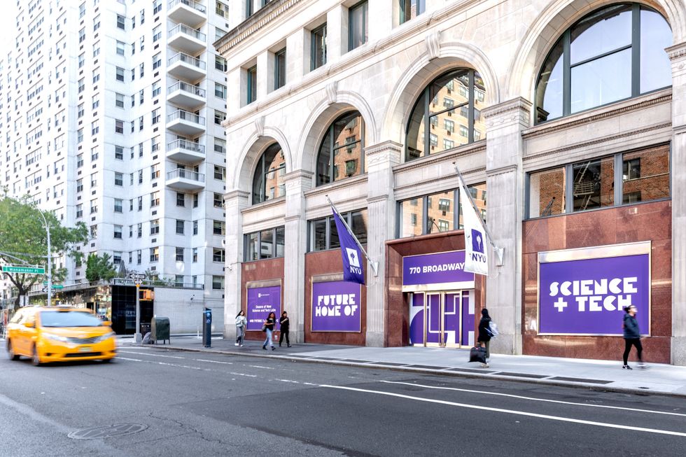 NYU building at 770 Broadway with Future Home of Science + Tech signs and street traffic
