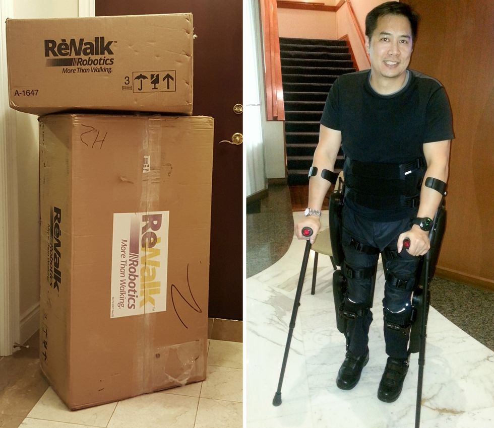 Person using a ReWalk exoskeleton with crutches beside stacked ReWalk shipping boxes