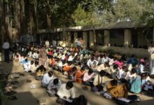 Rows of candidates writing an examination in a large hall in India