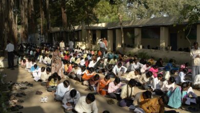 Rows of candidates writing an examination in a large hall in India