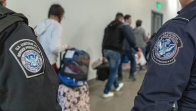 United States border officers processing people at the San Ysidro Port of Entry