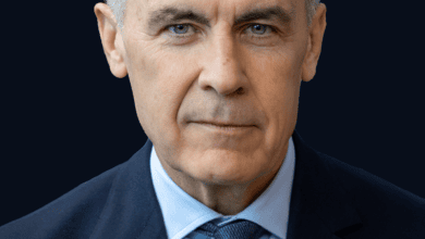 Portrait of Canadian Prime Minister Mark Carney against a blue background.