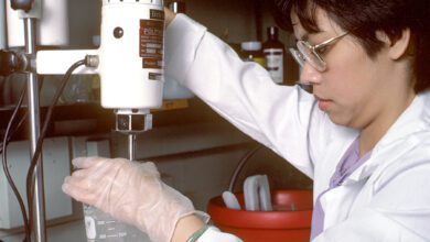 Laboratory technician conducting an assay in an archive photograph.