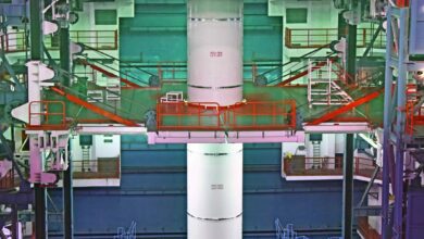 ISRO technicians work around the GSLV-F17 launch vehicle during integration for the EOS-05 mission