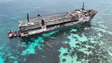 Aerial view of the fire-damaged MV June Aster with Philippine Coast Guard boats off Coron, Palawan.