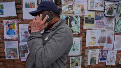 A man looks at photographs of people missing after the Nepal flash floods outside a Kathmandu hospital