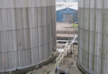 Rows of cylindrical oil storage tanks at a refinery