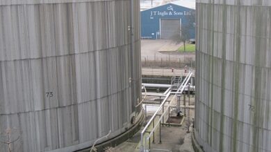 Rows of cylindrical oil storage tanks at a refinery