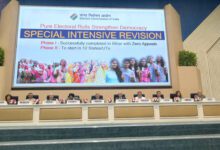 Election Commission officials, including Chief Election Commissioner Gyanesh Kumar, seated below a display about the Special Intensive Revision of electoral rolls.