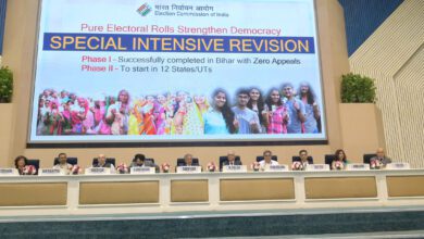 Election Commission officials, including Chief Election Commissioner Gyanesh Kumar, seated below a display about the Special Intensive Revision of electoral rolls.
